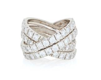 244 An 18K White Gold and Diamond Ring Of a cross over design featuring four rows of round diamonds weighing approximately 4.35 carats, set halfway down the shank Size: 7 1/2 15.6 grams gross Estimate: $5,500 - $6,500