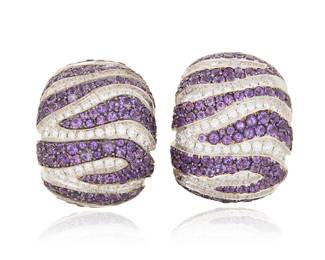 44 De Grisogono: A Pair of 18K Bi-Color Gold, Amethyst and Diamond Earrings Featuring alternating stripes of round amethyst accented by round diamonds weighing approximately 2.30 carats, signed de Grisogono, B0139, Geneve 2 pieces Measures: 1 x 3/4 in. 60.5 grams gross Estimate: $12,000 - $18,000