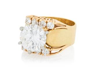 138 A 14K Gold and Diamond Ring Centering a round brilliant-cut diamond weighing approximately 3.34 carats, accented by eight round diamonds Size: 6 1/4 11.4 grams gross Accompanied by a GIA Report numbered #2183489729, dated June 09, 2017, stating the diamond as Natural with a color grade of F and a clarity grade of VS2, faint fluorescence. Estimate: $30,000 - $50,000