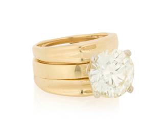 160 A 14K Gold and Diamond Ring and Jacket Wedding Set Featuring a high set solitaire round brilliant-cut diamond weighing 5.23 carats, together with a fluted ring jacket 2 pieces Size: 7 and 7 1/2 14.4 grams gross Accompanied by a GIA Report numbered #2245029281, dated August 6, 2026, stating the diamond as Natural with a color grade of N and a clarity grade of SI1, no fluorescence. Estimate: $20,000 - $25,000