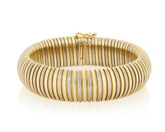 144 A 14K Bi-Color Gold Bracelet Of a tubogas design featuring alternating yellow and white gold bands, signed Italy Length: 7 1/2 in. Width: 5/8 in. 31.4 grams gross Estimate: $3,000 - $5,000