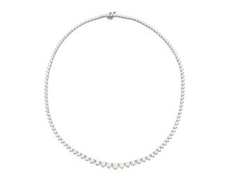 191 A 14K White Gold and Diamond Riviere Necklace Featuring graduated diamonds weighing approximately 10.40 carats Length: 17 1/2 in. 20.9 grams gross Estimate: $10,000 - $15,000