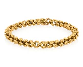 259 An 18K Gold Bracelet Of an 18k gold floral-pattern motif, composed of articulated floral links, accompanied by extra links for adjustment, with Italian assay mark 2 pieces Length: 8 in. 35.0 grams gross Estimate: $3,000 - $5,000