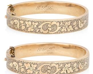 210 A Pair of Victorian 14K Gold and Black Enamel Bangles Of a hinged design featuring floral motifs, accented by black enamel 2 pieces Inner Circumference: 6 in. 28.8 grams gross Estimate: $3,000 - $5,000