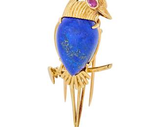 202 Cartier: An 18K Gold, Lapis Lazuli and Ruby Pin Featuring a bird sitting on a branch set with a pear-shaped lapis lazuli cabochon, finished with a pear-shaped ruby eye, signed Cartier, Paris, 015961 Measures: 2 x 1/2 in. 14.8 grams gross Estimate: $7,000 - $10,000