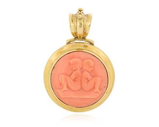 8 An 18K Gold and Coral Zodiac Pendant Centering a carved coral cabochon featuring the Gemini twins, set in a high polish gold frame, with French import marks Measures: 2 x 1 1/4 in. 18.6 grams gross Estimate: $1,500 - $2,000