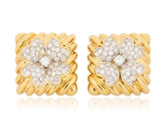 279 David Webb: A Pair of 18K Bi-Color Gold and Diamond Earrings Featuring a high polish yellow gold fluted design centering two white gold clover motifs set with round diamonds weighing approximately 1.75 carats, signed Webb 2 pieces Measures: 7/8 x 7/8 in. 34.1 grams gross Estimate: $7,000 - $10,000