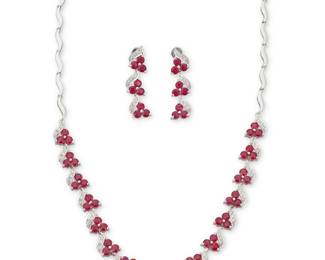 52 An 18K White Gold, Ruby and Diamond Necklace and Earring Set Of stylized wave design, set throughout with rubies and diamonds, estimated total ruby weight 10.20 carats and diamonds weight 0.48 carat 3 pieces Necklace: 15 3/4 in., Earrings: 1 1/4 in. 28.4 grams gross This lot is offered at no reserve. Estimate: $2,500 - $3,500