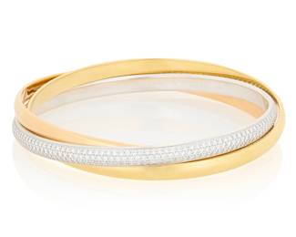 265 Cartier: An 18K Tri-Color Gold and Diamond 'Trinity' Bracelet Featuring high polish bands of yellow and rose gold together with a white gold band set with round diamonds weighing approximately 4.65 carats, signed Cartier 33125C Measures: 7 1/2 in. 67.7 grams gross Estimate: $20,000 - $25,000
