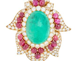 142 Harry Winston: An 18K Gold, Emerald, Ruby and Diamond Brooch Of a Mughal style design centering an oval emerald cabochon weighing approximately 66.77 carats, accented by oval ruby cabochons weighing approximately 26.64 carats and finished with round diamonds weighing approximately 19.84 carats, with Certificate of Authenticity from Harry Winston, with signed box, 1972 Measures: 3 1/4 x 2 3/4 in. 55.9 grams gross Estimate: $85,000 - $105,000