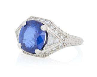 189 A Platinum, Sapphire and Diamond Ring Centering a Cushion mixed-cut sapphire weighing 5.06 carats, accented by round and French-cut diamonds Size: 7 1/4 9.3 grams gross Accompanied by a GIA Report numbered #2131694435, dated August 2, 2011, stating the Sapphire as natural Corundum of Madagascar origin with heat enhancement. Estimate: $5,000 - $7,000