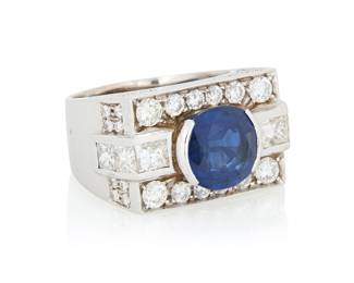 185 A 14K White Gold, Sapphire and Diamond Ring Centering an oval sapphire ring weighing approximately 4.60 carats, accented by round and princess cut diamonds weighing approximately 2.55 carats set in a geometric design size: 7 3/4 15.7 grams gross Estimate: $4,500 - $6,500