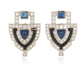123 A Pair of Art Deco Platinum, Sapphire, and Diamond Earrings Of a geometric shield design featuring, square-cut and shield-shaped sapphire cabochons, accented by single-cut diamonds and black enamel 2 pieces Measures: 7/8 x 5/8 in. 8.4 grams gross Estimate: $3,000 - $5,000
