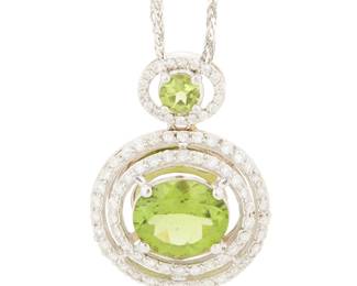 107 A 14K White Gold, Peridot and Diamond Necklace Featuring two oval peridots weighing approximately 6.10 and 9.81 carats, each encircled by round diamonds weighing approximately 1.20 carats total Length: 19 in. 11.0 grams gross Estimate: $1,800 - $2,500