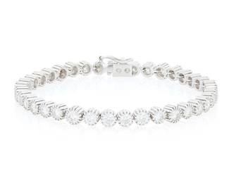 251 An 18K White Gold and Diamond Bracelet Featuring thirty-seven round diamonds weighing approximately 7.50 carats Length: 7 in. 21.2 grams gross Estimate: $5,000 - $7,000