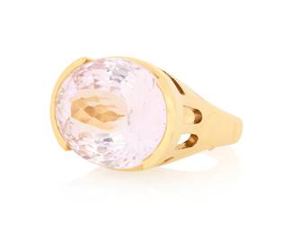 74 An 18K Gold and Kunzite Ring Centering an oval kunzite weighing approximately 38.68 carats, set in a high polish geometric design Size: 7 3/4 26.7 grams gross Estimate: $2,000 - $3,000