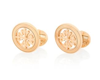 300 Patek Philippe: A Pair of 18K Rose Gold 'Calatrava Cross' Cufflinks Featuring a quatrefoil cross design, signed Patek Philippe Geneva 2 pieces Measures: 3/4 in. 16.9 grams gross Estimate: $2,500 - $3,500