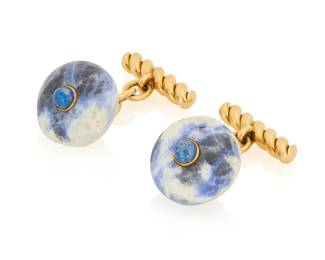 13 Gucci: A Pair of 18K Gold, Sodalite and Lapis Lazuli Cufflinks Each featuring polished sodalite centering a round lapis lazuli cabochon, finished with a twisted gold motif, signed Gucci, Italy 2 pieces Measures: 1 x 5/8 in. 11.07 grams gross This lot is being offered with no reserve Estimate: $1,000 - $2,000