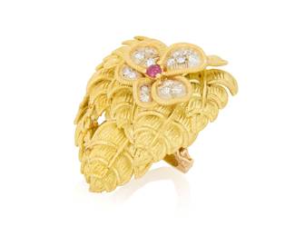 150 A Gold Enhancer Featuring a Tiffany and Co. Foliate Top Featuring a heart-shaped foliate motif design accented by single-cut diamonds and a round ruby, signed Tiffany & Co, Italy, finished with a 14k gold textured enhancer clasp Measures: 1 1/4 x 1 1/4 in. 19.2 grams gross Approximately 1.25" H Estimate: $2,000 - $2,500