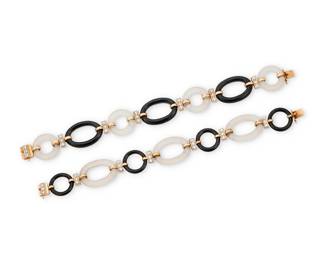 72 Pair of 14K Gold, Onyx and Rock Crystal Bracelets Featuring oval and round links of carved rock crystal quartz and onyx, accented by round diamonds weighing approximately 1.58 carats total 2 pieces Lengths: 8 1/4 in. and 7 3/4 in. 53.8 grams gross Estimate: $3,500 - $5,500