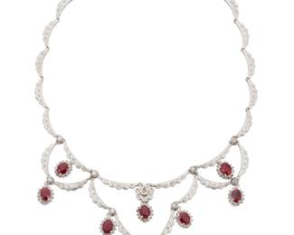 235 A 14K White Gold, Ruby and Diamond Necklace Of a scalloped motif centering oval rubies weighing approximately 13.52 carats, accented by round diamonds weighing approximately 2.90 carats Measures: 16 5/8 in. 53.6 grams gross This lot is offered at no reserve. Estimate: $3,500 - $5,500