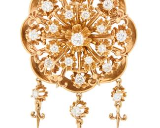 282 A 14K Gold and Diamond Brooch Of an open floral motif, set with round diamonds weighing approximately 1.20 carats, signed PS Measures: 1 1/4 in. 19.3 grams gross Estimate: $1,800 - $2,200