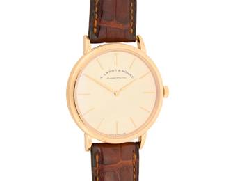 312 A. Lange & Sohne: An 18K Rose Gold 'Saxiona Thin' Watch Dial: 30.00 mm, round with baton marks Case: 38.00 mm Case number: 238338, movement 128205 Closure: brown leather strap with 18k rose gold buckle clasp Signed: dial, case, movement and clasp, accompanied by original box and papers Inner circumference: 6 3/4 - 8 1/2 in. 61.7 grams gross Estimate: $12,000 - $18,000