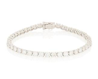 242 An 18K White Gold and Diamond Bracelet Of a single line design featuring forty-two round diamonds weighing approximately diamonds 7.80 carats Length: 7 in. 10.7 grams gross Estimate: $3,000 - $5,000