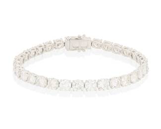 192 An 18K White Gold and Diamond Bracelet Of a single line design featuring thirty round diamonds weighing approximately 14.85 carats Length: 7 in. 16.6 grams gross Estimate: $7,500 - $8,500