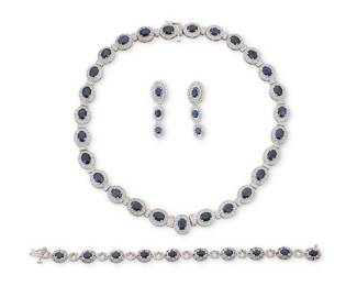 182 A 14K White Gold, Sapphire and Diamond Suite Comprising a necklace, bracelet, and pair of earrings, each designed with oval-cut sapphires framed by a halo of round diamonds, estimated total sapphires weight 61.20 carats and diamonds 6.50 carats 4 pieces Necklace:17 in., Bracelet: 7 in., Earrings: 1 1/2 in. 99.4 grams gross This lot is offered at no reserve. Estimate: $7,000 - $9,000