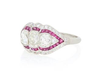 121 A Platinum, Diamond and Ruby Ring Featuring three old mine-cut diamonds weighing approximately 1.72 carats, accented by square step-cut rubies weighing approximately 0.80 carat total Size: 8 1/4 5.40 grams gross Estimate: $3,500 - $5,500