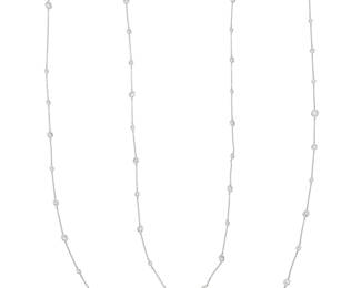 111 A 14K White Gold and Diamond Long Chain Featuring stations set with graduated round diamonds weighing approximately 14.80 carats Length: 62 1/2 in. 15.3 grams gross Estimate: $6,500 - $8,500