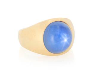 153 A 14K Gold and Star Sapphire Ring Featuring a cabochon star sapphire weighing approximately 16.74 carats, set in a polished 14K yellow gold mounting Size: 10 17.1 grams gross Estimate: $2,000 - $3,000