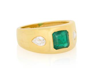 83 An 18K Gold, Emerald and Diamond Ring Featuring a gypsy set emerald weighing approximately 1.60 carats, flanked by two pear-shaped step-cut diamonds Size: 7 7.2 grams gross Estimate: $1,800 - $2,200