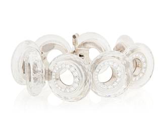 129 Aletto Bros: An 18K White Gold, Rock Crystal and Diamond Bracelet Featuring eight faceted rock crystal quartz discs, lined by graduated round diamonds weighing approximately 7.90 carats, signed Aletto Bros, 82210 Length: 8 in., Width: 1 1/7 in. 110.9 grams gross Estimate: $20,000 - $30,000