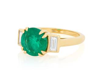 258 A 18K Gold and Emerald Ring Featuring a round emerald weighing approximately 2.45 carats, accented by baguette diamonds weighing 0.45 carat Size: 7 3/4 6.6 grams Estimate: $3,500 - $5,500