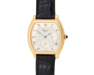 317 Chopard: An 18K Gold 'Classique Tonneau' Watch Dial: 26.00 mm, with a rectangular curved dial featuring Roman numeral hour markers Case: 33.00 mm Case number: 373434, 2248 Closure: black leather strap and 18k gold buckle clasp Signed: dial, case, strap and clasp Inner circumference: 7 1/4 - 8 1/2 in. 56.2 grams gross Estimate: $7,000 - $10,000