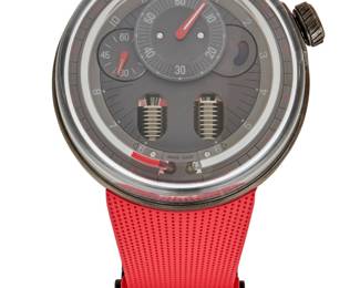 324 HYT: A Gun Metal 'HO' Watch Dial: 42.00 mm, round gun metal dial with Arabic hour markers Case: 48.00 mmm Case number: 266 Closure: red rubber strap with titanium deployment clasp Signed: dial, case and clasp, with original box Inner circumference: 7 - 8 1/2 in. 164.6 grams gross Estimate: $18,000 - $25,000
