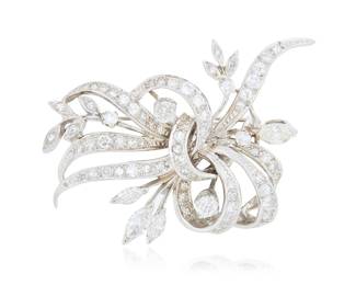 296 A 14K White Gold and Diamond Brooch Of a swirling ribbon design set with marquise-shaped, round, single-cut, and old mine-cut diamonds weighing approximately 3.35 carats Measures: 2 x 1 1/4 in. 11.5 grams gross Estimate: $2,500 - $3,500
