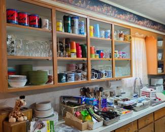 A kitchen FULL of modern and vintage dishes