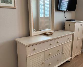 COASTAL COTTAGE QUEEN BEDROOM COLLECTION: Distressed Cream Finish • Louvered/Shutter Detailing • Wood Drawer Boxes • Metal Drawer Glides Coastal Cottage Queen Headboard: Distressed Cream Finish • Louvered/Shutter Panels • Decorative Posts & Finials Coastal Cottage Dresser & Mirror: Louvered Cabinet Doors • Multiple Storage Drawers • Wood Drawer Boxes • Metal Drawer Glides • Coordinating Framed Mirror. Coastal Cottage Nightstands: Distressed Cream Finish • Drawer with Metal Glides • Open Display/Storage Shelf • Bun Feet