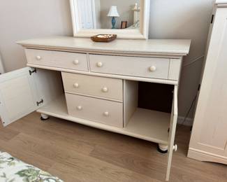COASTAL COTTAGE QUEEN BEDROOM COLLECTION: Distressed Cream Finish • Louvered/Shutter Detailing • Wood Drawer Boxes • Metal Drawer Glides Coastal Cottage Queen Headboard: Distressed Cream Finish • Louvered/Shutter Panels • Decorative Posts & Finials Coastal Cottage Dresser & Mirror: Louvered Cabinet Doors • Multiple Storage Drawers • Wood Drawer Boxes • Metal Drawer Glides • Coordinating Framed Mirror. Coastal Cottage Nightstands: Distressed Cream Finish • Drawer with Metal Glides • Open Display/Storage Shelf • Bun Feet