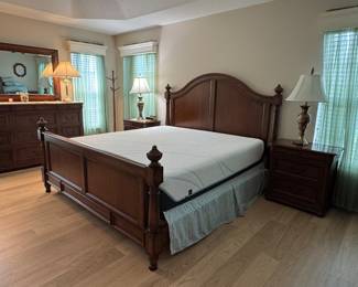 TOMMY BAHAMA–STYLE TROPICAL RESORT KING BEDROOM COLLECTION: Rich Warm-Wood Finish • Dovetail Drawer Construction • Carved Tropical Leaf Accents • Statement Panel Bed • Beveled Mirror • Coordinating Case Pieces: King Panel Bed Arched Headboard • Panel Footboard • Turned Posts & Finials • Wood Side Rails Dresser & Beveled Mirror Dovetail Drawers • Carved Tropical Leaf Accents • 12 Drawers Tall 5-Drawer Chest Dovetail Drawer Construction • Rich Warm-Wood Finish • 6 Drawers Two 2-Drawer Nightstands Dovetail Drawer Construction