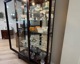 LARGE LIGHTED SLIDING-GLASS CURIO DISPLAY CABINETS — 2 MATCHING Oversized Statement Display Cabinet • Approx. 83 x 46 x 14.5 • Rich Dark Wood Finish • Sliding Glass Front Doors • Glass Side Panels • Full Mirrored Back • Multiple Glass Display Shelves • Interior Display Lighting • Elevated Furniture-Style Base