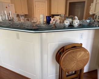An Assortment of Glassware and 4 Piece Set w/Rack TV Trays