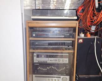 Turn table, two CD players, two cassette decks, equalizer, pair of speakers and stereo cabinet
