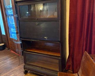 Mahogany lawyers cabinet with drop front desk. One door needs attention. On casters