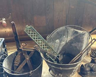 Buckets with handles, various shovels, ice tongs, grates
