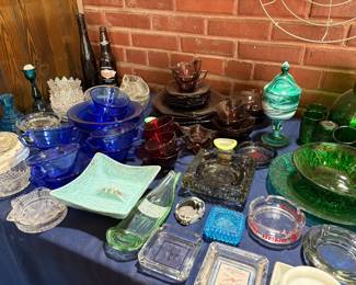 Collection of cobalt blue 2 handled soup bowns, servicing bowls;Amethyst color cup and saucers , plates; Rare green slag candy dish with lid; Assorted ashtrays; Green depression glass Pitcher with 7 glasses, plater and bowl