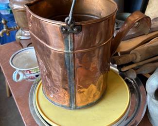 Copper pail with handle and pourer.